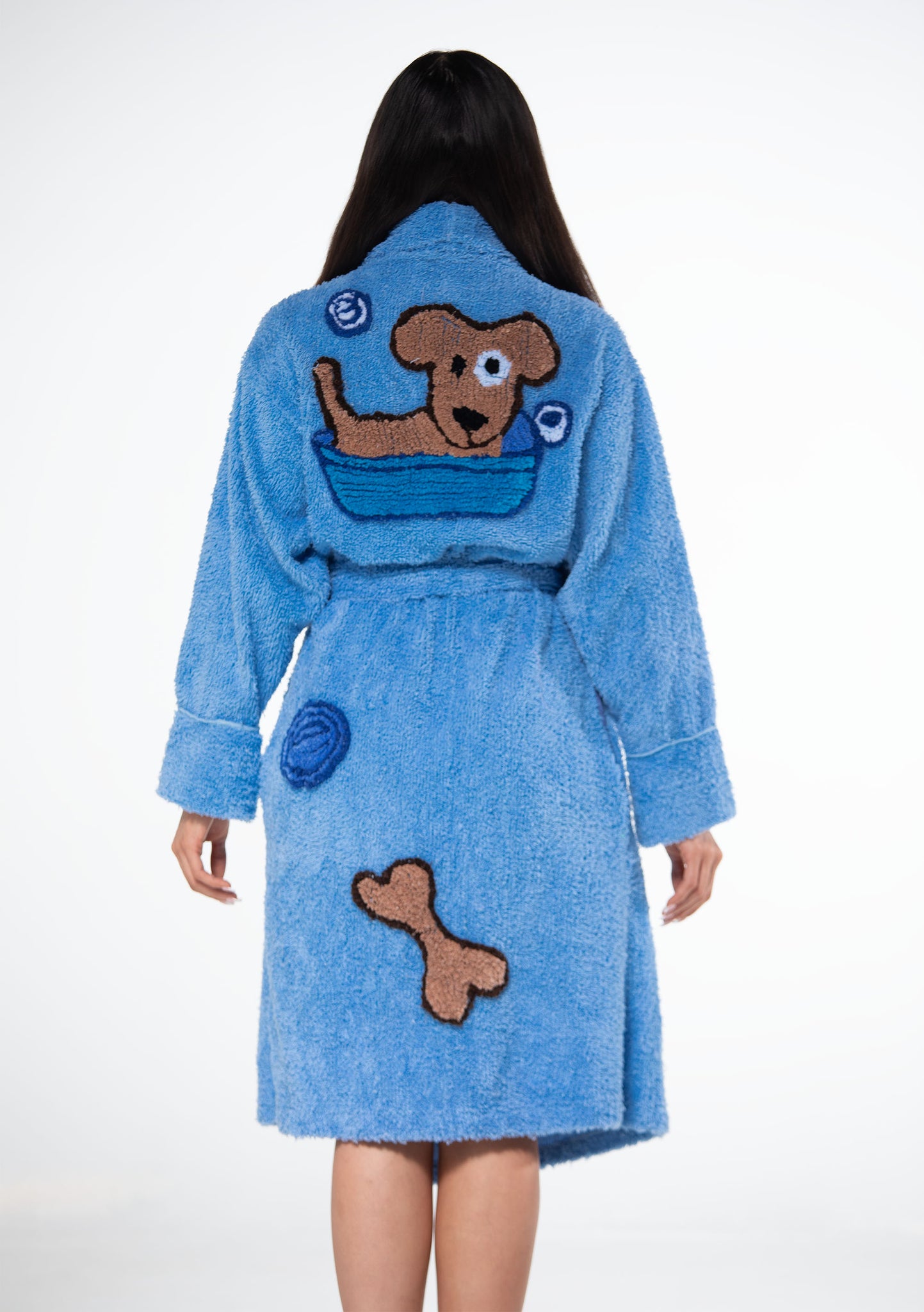 back of doggie wash chenille robe showing a tufted dog in a bath tub and bubbles and a dog bone